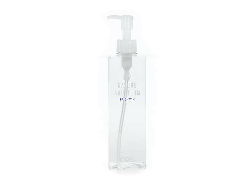 ADA Brighty K liquid fertilizer bottle with clear pump dispenser and minimalist labeling, designed for planted aquarium nutrient supplementation