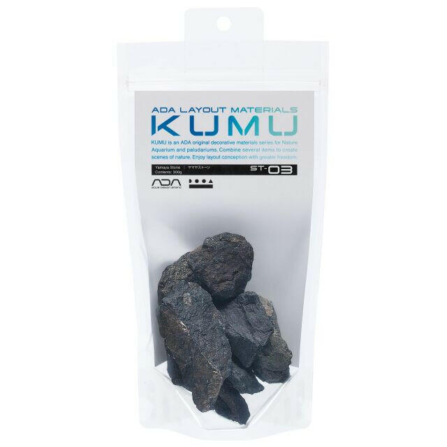 ADA KUMU ST-03 Yamaya Stone (300g) in retail packaging, showcasing dark, rounded aquascaping stones with natural texture and earthy tones